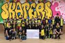 Skaters Roller Hockey Club team with the sponsorship cheque.