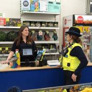 A PCSO talking to staff at The Factory Shop in Whittlesey