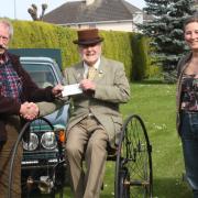 Colin Bedford receives his donation.
