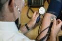 A GP checks a patient's blood pressure.  Photo credit: Anthony Devlin/PA Wire
