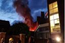 Firefighters arrived to find a 'well-developed' fire involving the roof of a mid-terraced four-storey building.