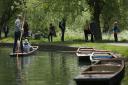 People punting on the River Cam in Cambridge as they enjoy the sunshine.