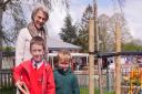 The Duchess of Gloucester with two Brington primary school children planting a commemorative tree.