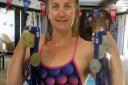 Lucy Ryan with the clutch of medals she won at the British Masters Swimming Championships. PHOTO: Wisbech Swimming Club.