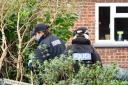 Police searching gardens around the house where Eliza Bibby was murdered.