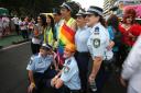 New South Wales state police pose with participants in an annual gay and lesbian Mardi Gras parade in Sydney (AP)