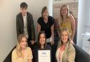 Chief Executive Anne Campbell (back row middle) and the Embrace team with their national award for outstanding services.