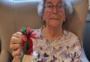A resident holds up a hand made Christmas decoration which are on sale at Lyncroft Care Home, in Wisbech.