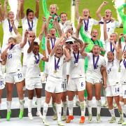 England's Leah Williamson and Millie Bright lift the trophy with team-mates after winning the UEFA Women's Euro 2022 final at Wembley Stadium
