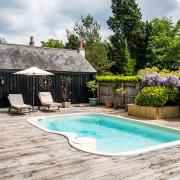 A decking surrounds the pool