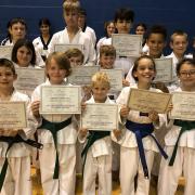 Students from the Mark Farnham Schools of Tae Kwon-Do celebrate their colour belt gradings at Ely