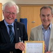 FLUA secretary Mark Collins (R) is pictured receiving the gold award for best newsletter in Railfuture's annual user group competition.