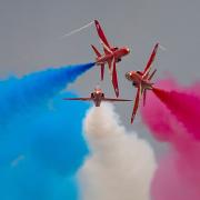 The Red Arrows display team in action at the Duxford Summer Air Show at IWM Duxford.