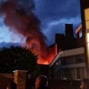 Firefighters arrived to find a 'well-developed' fire involving the roof of a mid-terraced four-storey building.