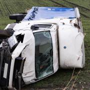 A van left on the side of the road after being blown down a verge in to a field at Forty Foot in Ramsey.