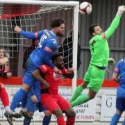 Stamford goalkeeper Danny Haystead punches clear to thwart a Wisbech attack.