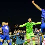 Whittlesey Athletic celebrate after goalkeeper Aaron Bellairs makes the winning save.