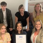 Chief Executive Anne Campbell (back row middle) and the Embrace team with their national award for outstanding services.