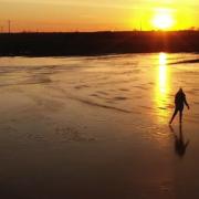 Adam Giles captured drone footage of his daughter Alesya skating at sunrise over a frozen wheat field that flooded in Welney.