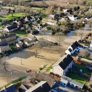 Anglian Water has been ordered to repay ?8.5m to its customers by the regulator Ofwat. Pictured: a neighbourhood flooded in Huntingdonshire.