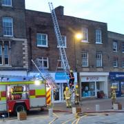 Firefighters tackled a roof blaze above the Sue Ryder shop in Wisbech Market Place.