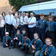 Wisbech Scout leaders Caroline Kooreman and Graham Martin receiving a cheque from Wisbech Freemasons David Broker and Michael Humprey, pictured with some of the scouts.