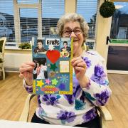 Resident, Betty, showcasing her Elvis scrapbook masterpiece she created in craft club, in honour of the King of rock and roll on his birthday.
