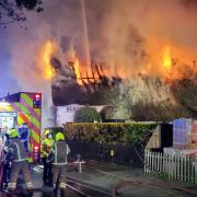Firefighters battle a blaze at a thatched cottage at Hengrave in Suffolk