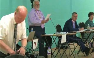Tory opposition leader Steve Count packs up as he prepares to head for the exit, abandoning a full meeting of the county council in July. It was being chaired by Cllr Derek Giles (second left) who has stepped down because of ill-health.