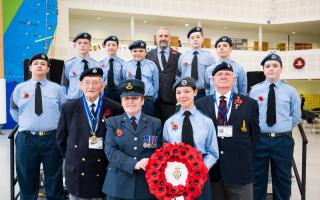The Air Training Corps pupils at Thomas Clarkson Academy pose with veterans and their school principal with their Armistice Day wreath.