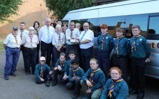 Wisbech Scout leaders Caroline Kooreman and Graham Martin receiving a cheque from Wisbech Freemasons David Broker and Michael Humprey, pictured with some of the scouts.
