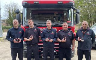 The firefighters with their Coronation Medals.